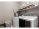 Laundry room with washer, dryer, and shelving at 21720 N 265Th Dr, Buckeye, AZ 85396