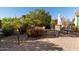 Relaxing patio with table and chairs, surrounded by desert landscaping at 21720 N 265Th Dr, Buckeye, AZ 85396