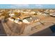 Aerial view of a single-Gathering home with outbuildings, situated on a large lot at 22352 W Meade Ln, Buckeye, AZ 85326