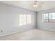 Spacious bedroom with ceiling fan and window at 22352 W Meade Ln, Buckeye, AZ 85326