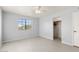 Simple bedroom with ceiling fan and window at 22352 W Meade Ln, Buckeye, AZ 85326