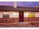 House exterior at dusk with a red front door and brick accents at 22352 W Meade Ln, Buckeye, AZ 85326