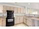 Bright kitchen with ample wood cabinets and black appliances at 22352 W Meade Ln, Buckeye, AZ 85326