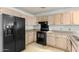 Kitchen with black appliances and wood cabinets at 22352 W Meade Ln, Buckeye, AZ 85326