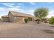 Landscaped backyard with gravel and mature trees at 22915 N Wagon Wheel Dr, Sun City West, AZ 85375