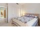 Bright bedroom with a queen bed and built-in shelving at 22915 N Wagon Wheel Dr, Sun City West, AZ 85375