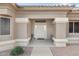 Front entrance with a light-colored door and a small bench at 22915 N Wagon Wheel Dr, Sun City West, AZ 85375