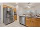 Modern kitchen with stainless steel refrigerator and granite island at 22915 N Wagon Wheel Dr, Sun City West, AZ 85375