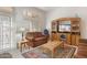 Living room with a brown couch and wooden entertainment center at 22915 N Wagon Wheel Dr, Sun City West, AZ 85375