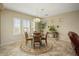 Bright dining room features a round table, four chairs, and an area rug at 23313 N De La Guerra Ct, Sun City West, AZ 85375