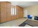 Garage with built-in storage cabinets and flooring at 23313 N De La Guerra Ct, Sun City West, AZ 85375