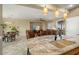 Kitchen island with granite countertop and double sink overlooks living room at 23313 N De La Guerra Ct, Sun City West, AZ 85375