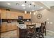 Kitchen features granite island, light wood cabinets, and tile flooring at 23313 N De La Guerra Ct, Sun City West, AZ 85375