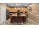 Kitchen boasts granite countertops, light wood cabinets, and a breakfast bar at 23313 N De La Guerra Ct, Sun City West, AZ 85375