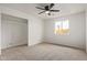 This bedroom features neutral walls, carpet, a window, and a closet space for storage at 2345 W Monroe St # 4, Phoenix, AZ 85009