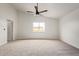 Open bedroom with carpet, white walls, ceiling fan, and a window at 2345 W Monroe St # 4, Phoenix, AZ 85009