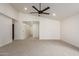 Bright living room features a ceiling fan and neutral carpet at 2345 W Monroe St # 4, Phoenix, AZ 85009