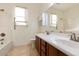 Bathroom featuring a double sink vanity, bathtub with shower, and natural light at 2471 E Jade Dr, Chandler, AZ 85286