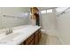 Well-lit bathroom featuring a single sink vanity, bathtub, and a mirror at 2471 E Jade Dr, Chandler, AZ 85286