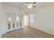 Inviting bedroom with laminate flooring, a ceiling fan, and mirrored closet doors at 2471 E Jade Dr, Chandler, AZ 85286