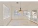 Well-lit dining area with travertine floors and a stylish pendant light fixture at 2471 E Jade Dr, Chandler, AZ 85286