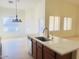 Kitchen features an island with seating and a view into the adjacent dining area at 2471 E Jade Dr, Chandler, AZ 85286