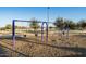 Community playground with swings, mature trees, and beautiful blue sky view at 2471 E Jade Dr, Chandler, AZ 85286