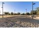 Community sand volleyball court surrounded by lush trees on a sunny day at 2471 E Jade Dr, Chandler, AZ 85286