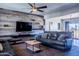 Spacious living room showcasing a large TV and wood-plank accent wall at 2524 S El Paradiso Dr # 70, Mesa, AZ 85202