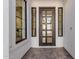 Modern entryway with a black framed glass front door and tile flooring at 2553 E Virginia Cir, Mesa, AZ 85213