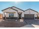 Stunning ranch-style home with a modern gray-toned garage door and brick accents at 2553 E Virginia Cir, Mesa, AZ 85213