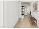 Inviting hallway featuring a modern bench and stylish artwork at 2553 E Virginia Cir, Mesa, AZ 85213