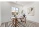 Bright and airy home office featuring a wooden desk and modern artwork at 2553 E Virginia Cir, Mesa, AZ 85213