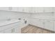 Laundry room with white cabinets, marble countertop, and tile floor at 2553 E Virginia Cir, Mesa, AZ 85213