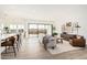 Bright living room features sliding glass doors, hardwood floors, and a neutral color palette at 2553 E Virginia Cir, Mesa, AZ 85213