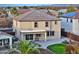 Two-story house with backyard patio, and grassy area; mountain views in background at 29405 W Columbus Ave, Buckeye, AZ 85396