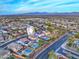 Aerial view of community with a two-story house with pool, and mountain views at 29405 W Columbus Ave, Buckeye, AZ 85396