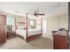 Main bedroom with plush carpet, a post bed, and ample natural light at 29405 W Columbus Ave, Buckeye, AZ 85396