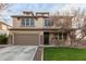 Two-story house with brown garage door and a neatly landscaped yard at 29405 W Columbus Ave, Buckeye, AZ 85396