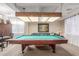 Game room features a pool table, comfortable seating, and large windows at 29405 W Columbus Ave, Buckeye, AZ 85396