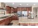 Modern kitchen boasts stainless steel appliances and rich wood cabinetry at 29405 W Columbus Ave, Buckeye, AZ 85396