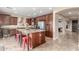 Island kitchen with granite countertops and dark wood cabinets at 29405 W Columbus Ave, Buckeye, AZ 85396