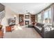 Relaxing living room with a fireplace and large TV at 29405 W Columbus Ave, Buckeye, AZ 85396