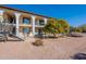 Second exterior view of a two-story building with balconies, landscaping, and a stairway at 3270 S Goldfield Rd # 816, Apache Junction, AZ 85119