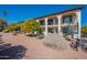 Exterior view of a two-story building with balconies, landscaping, and a stairway at 3270 S Goldfield Rd # 816, Apache Junction, AZ 85119