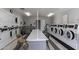 Clean laundry room with multiple washers, dryers, folding table and chairs, and coin operated machines at 3270 S Goldfield Rd # 816, Apache Junction, AZ 85119