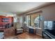 Living room with hardwood floors, comfortable seating and bay window with palm tree view at 3270 S Goldfield Rd # 816, Apache Junction, AZ 85119