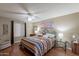 Main bedroom with king-size bed, wood floors, and southwestern decor at 3270 S Goldfield Rd # 816, Apache Junction, AZ 85119