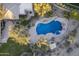 Backyard aerial view of a freeform private pool and desert landscaping at 3439 E Tonto Dr, Phoenix, AZ 85044