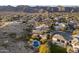 Expansive aerial view showcases the community and backyard pools against a mountain backdrop at 3439 E Tonto Dr, Phoenix, AZ 85044